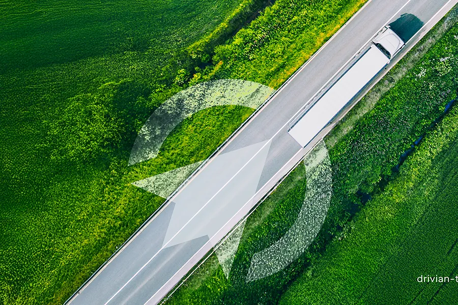 Aerial view of a truck on a country road, with the Drivian symbol drawn over it