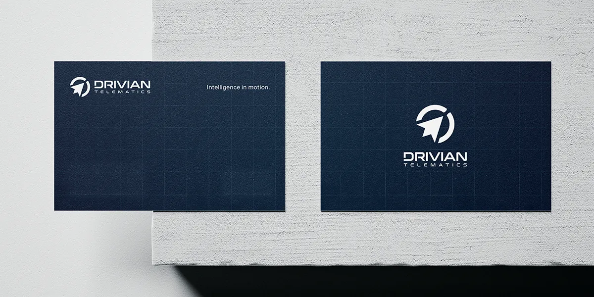 Drivian business cards on a concrete ledge, with the tagline Intelligence in motion
